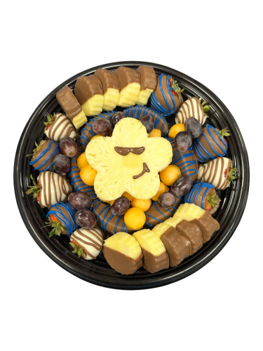 Fruit platter with pineapple daisy and funny face, chocolate covered strawberries and apples with melon and grapes.