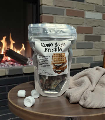Some More Brickle bag on table in front of a fireplace with marshmallows and a blanket