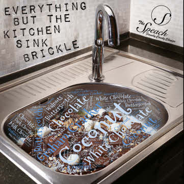 Everything But The Kitchen Sink Brickle label - a stainless steel sink filled with chocolate, marshmallows and other ingredients with a word cloud of all ingredients and white tile backsplash