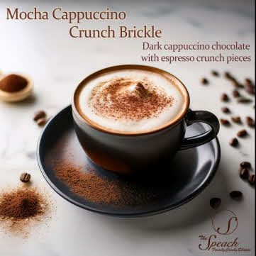 Mocha Cappuccino Crunch Brickle label - black coffee cup with saucer filled with frothy cappuccino dusted with cocoa on white counter surrounded by coffee beans and cocoa powder
